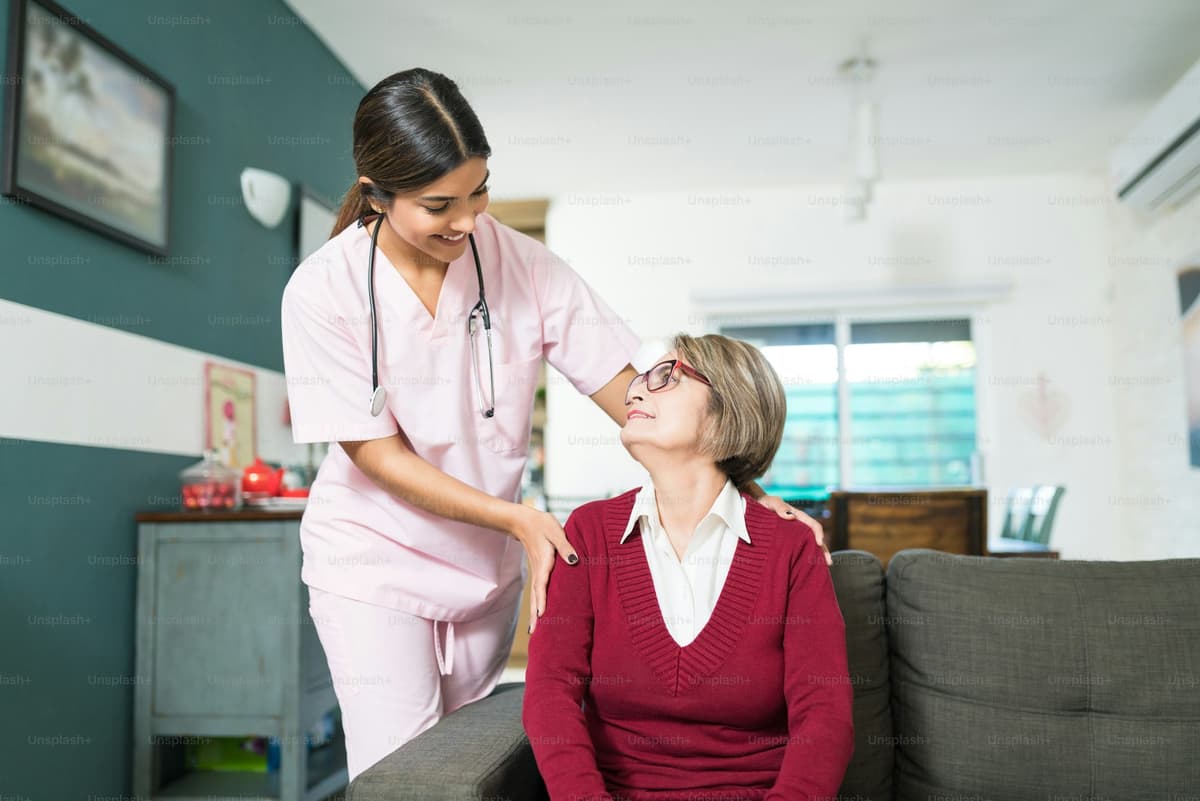 Caregiver interacting warmly with elderly patient
