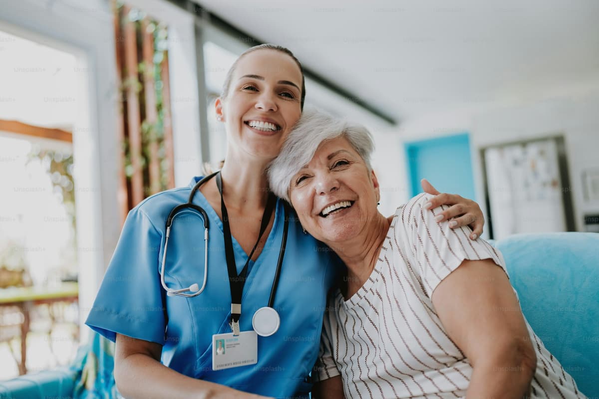 Healthcare professional embracing senior patient
